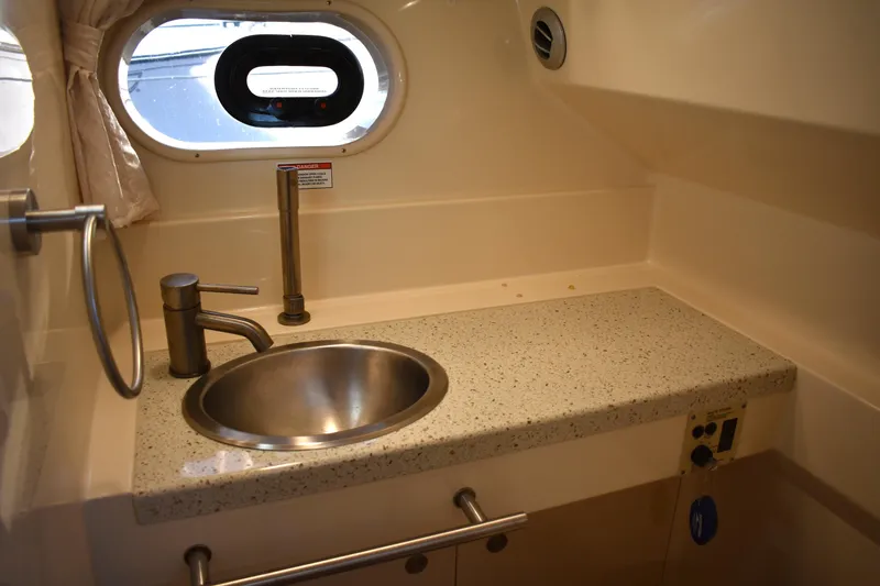Slide: The Image of 2016 Sea Ray Sundancer 310 bathroom with sink, countertop, and porthole window. - 27