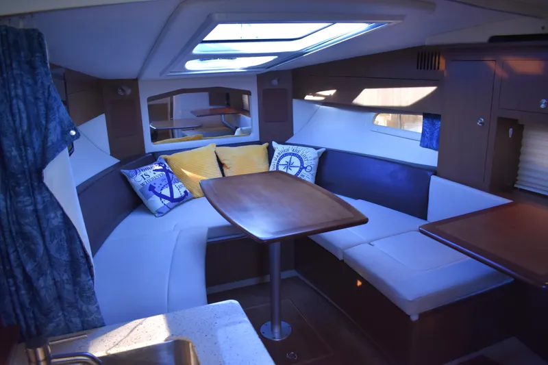Slide: The Image of Interior of 2016 Sea Ray Sundancer 310 yacht with cozy seating and nautical decor. - 29