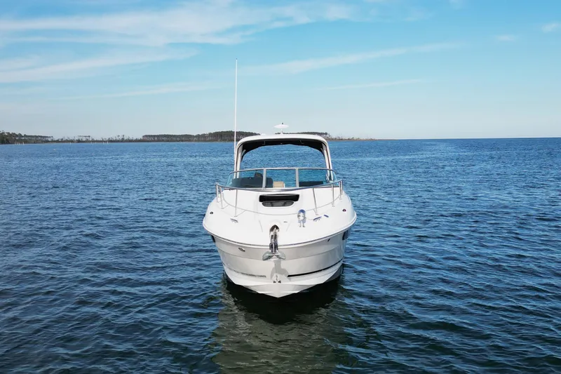 Slide: The Image of 2016 Sea Ray Sundancer 310 yacht on open water under clear blue sky. - 3
