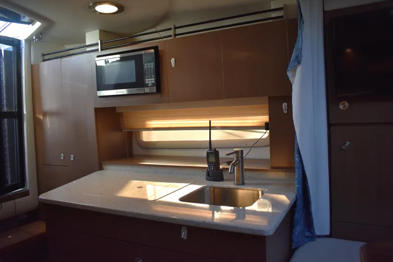Slide: The Image of Interior of 2016 Sea Ray Sundancer 310 yacht kitchen with sink and microwave. - 35