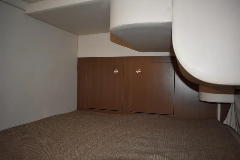 Slide: The Image of Interior cabin storage of 2016 Sea Ray Sundancer 310 boat, featuring wooden cabinets. - 38