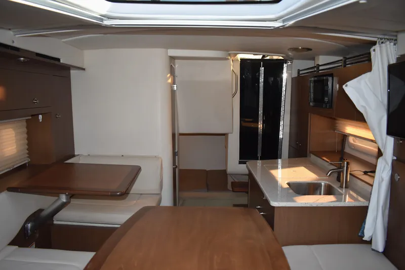 Slide: The Image of Interior of 2016 Sea Ray Sundancer 310, featuring kitchen and seating area. - 39