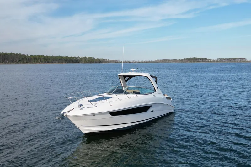 Slide: The Image of 2016 Sea Ray Sundancer 310 yacht on calm blue waters under a clear sky. - 4