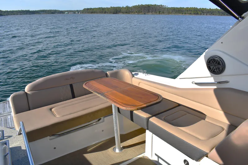Slide: The Image of 2016 Sea Ray Sundancer 310 boat interior with seating and table on open water. - 9
