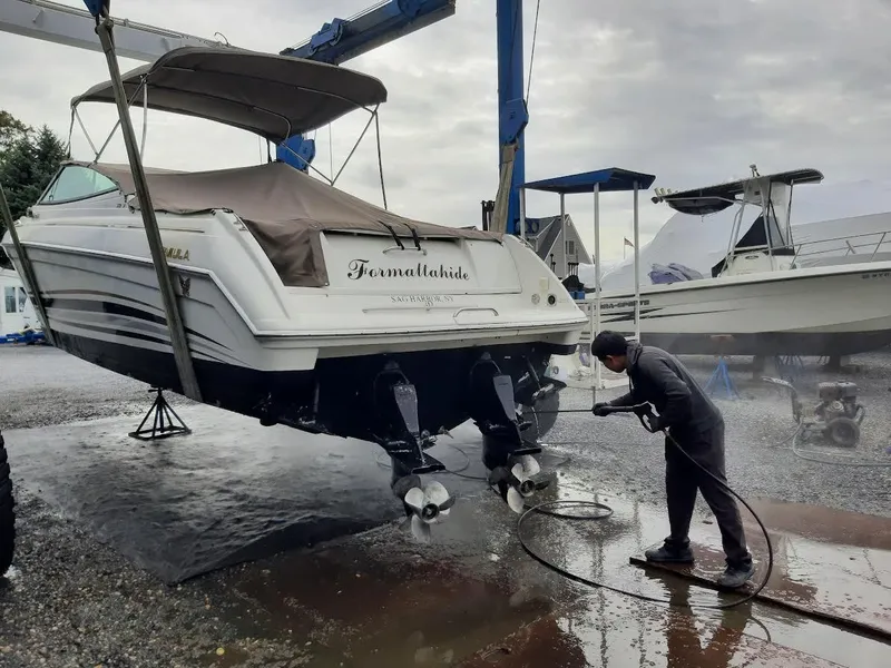 Slide: The Image of Man cleaning 1999 Formula 33 SS boat with pressure washer. - 2