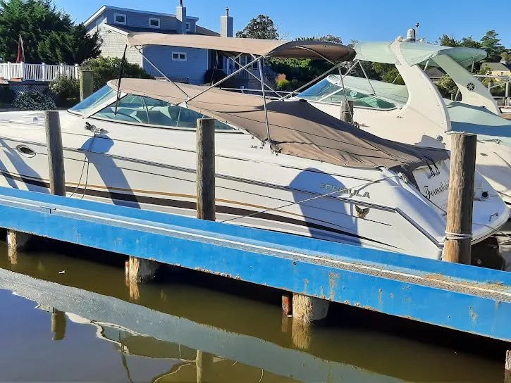 Slide: The Image of 1999 Formula 33 SS boat docked at marina. - 3