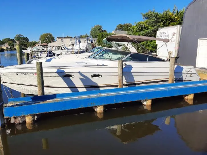 Slide: The Image of 1999 Formula 33 SS boat docked at marina. - 4