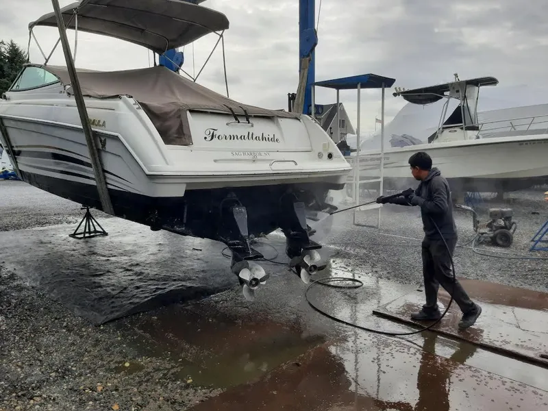 Slide: The Image of Man cleaning 1999 Formula 33 SS boat with pressure washer. - 6