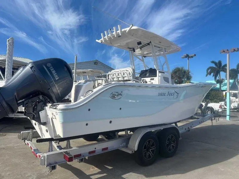 Slide: The Image of 2022 Sea Fox 268 Commander boat on trailer, blue sky. - 1