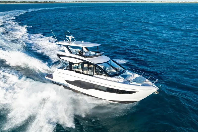 The Image of 2026 Cruisers Yachts 50 Fly cruising on open blue ocean waters. - 0