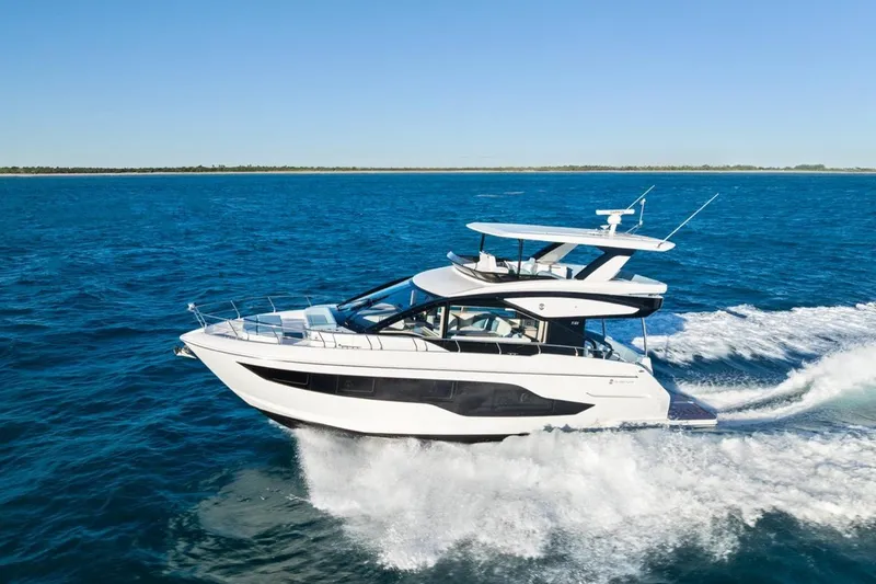 Slide: The Image of 2026 Cruisers Yachts 50 Fly cruising on open blue ocean waters. - 38