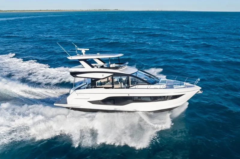 Slide: The Image of 2026 Cruisers Yachts 50 Fly cruising on open blue ocean waters. - 40