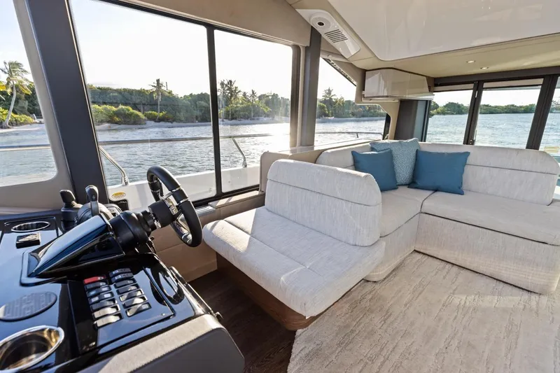 Slide: The Image of Luxurious interior of 2026 Cruisers Yachts 50 Fly with plush seating and scenic water views. - 48