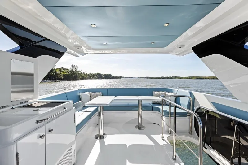 Slide: The Image of Luxurious 2026 Cruisers Yachts 50 Fly with spacious outdoor seating and scenic water view. - 54