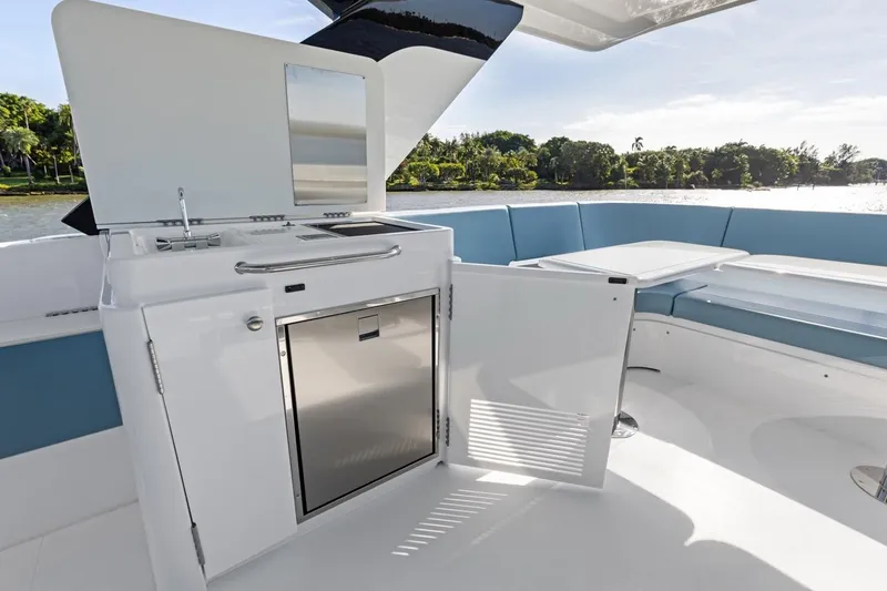 Slide: The Image of Luxurious outdoor kitchen on 2026 Cruisers Yachts 50 Fly with seating and scenic view. - 57