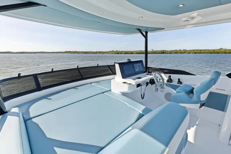 Slide: The Image of Luxurious 2026 Cruisers Yachts 50 Fly helm with modern controls and panoramic water view. - 63