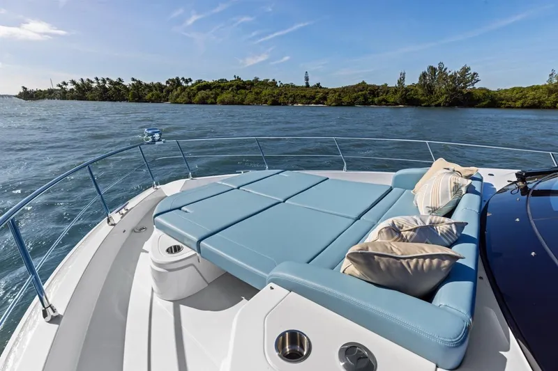 Slide: The Image of Luxurious 2026 Cruisers Yachts 50 Fly with sunbed, cruising on serene waters. - 65