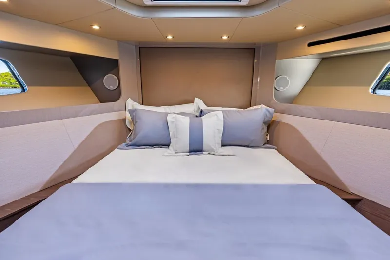 Slide: The Image of Luxurious bedroom interior of 2026 Cruisers Yachts 50 Fly, featuring elegant bedding and ambient lighting. - 67