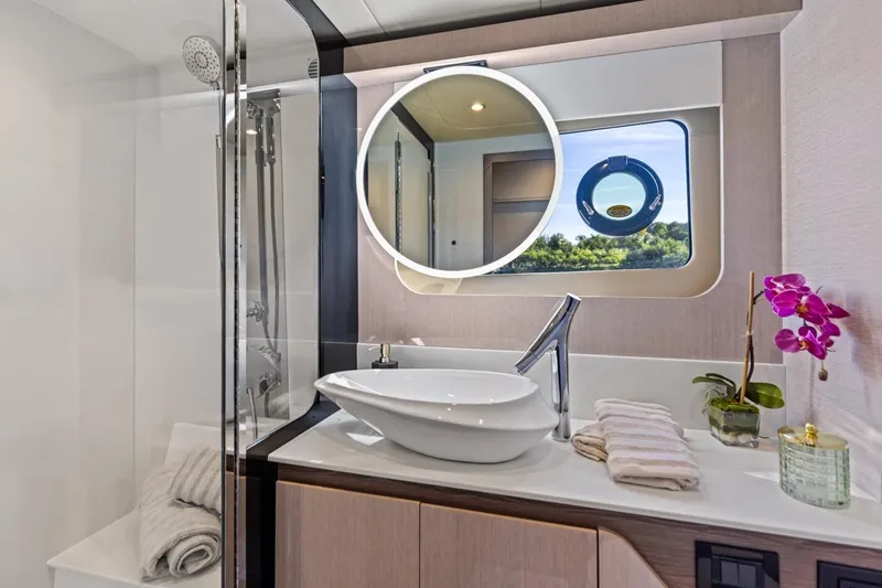 Slide: The Image of Luxurious bathroom in 2026 Cruisers Yachts 50 Fly, featuring modern fixtures and elegant design. - 69