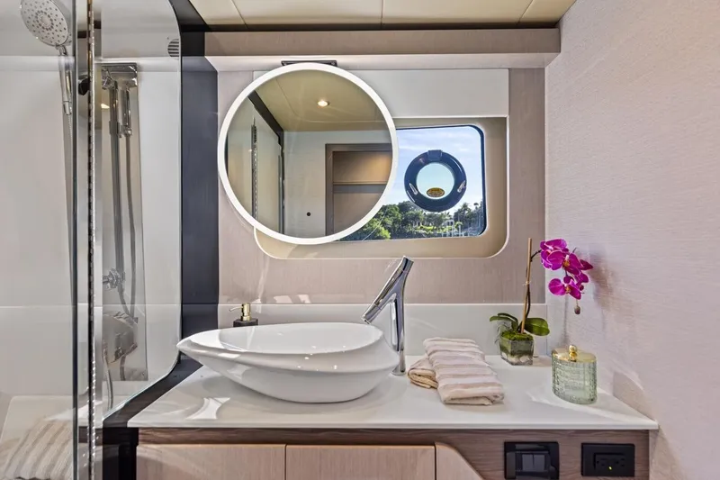 Slide: The Image of Luxurious bathroom interior of 2026 Cruisers Yachts 50 Fly with modern fixtures and elegant decor. - 70