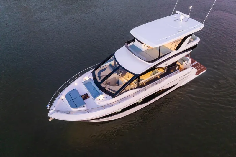 Slide: The Image of 2026 Cruisers Yachts 50 Fly luxury yacht on calm water, aerial view. - 8