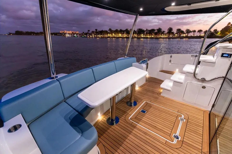 Slide: The Image of Luxurious 2026 Cruisers Yachts 50 Fly deck with elegant seating and scenic waterfront view. - 81