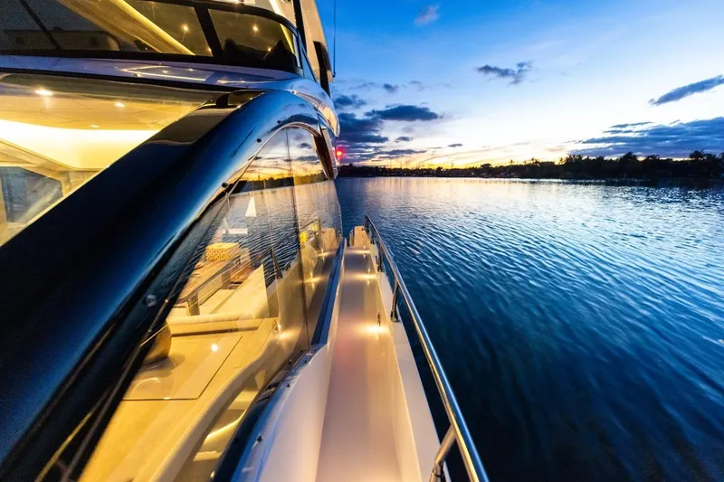 Slide: The Image of 2026 Cruisers Yachts 50 Fly at sunset on tranquil water. - 84