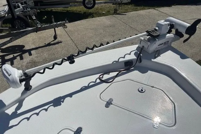 Slide: The Image of Trolling motor on a 2022 Frontier 2104 boat, parked on concrete pavement. - 10