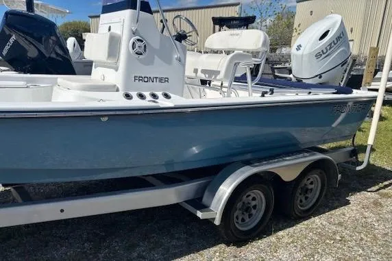 Slide: The Image of 2022 Frontier 2104 boat on trailer with Suzuki outboard motor. - 2