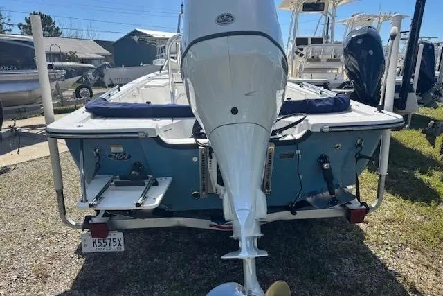Slide: The Image of 2022 Frontier 2104 boat with outboard motor, parked on gravel lot. - 3