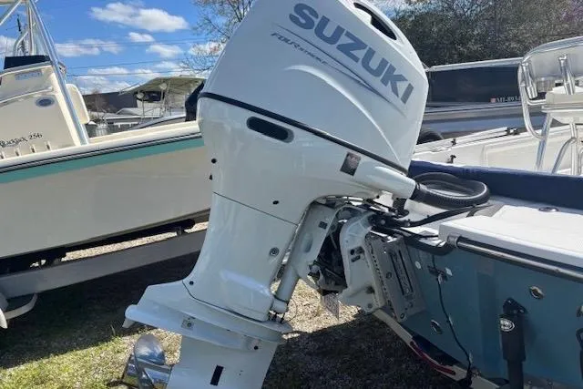 Slide: The Image of Outboard motor on a Frontier 2104 boat, 2022 model, under clear blue skies. - 4