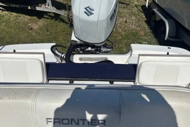 Slide: The Image of Boat with Suzuki outboard motor, Frontier 2104 model, 2022, on grassy area. - 6
