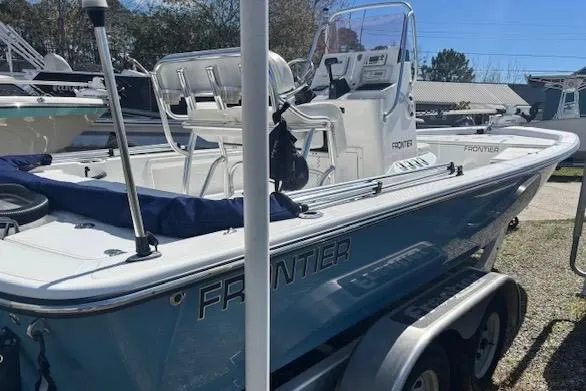 Slide: The Image of 2022 Frontier 2104 boat on trailer, featuring sleek design and modern console. - 7