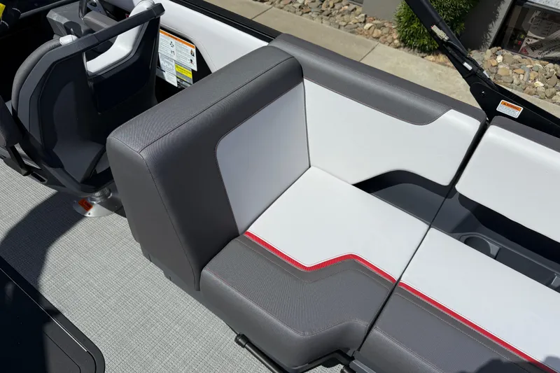 Slide: The Image of 2025 Manitou Cruise boat interior with modern gray and white seating, featuring red accents. - 10