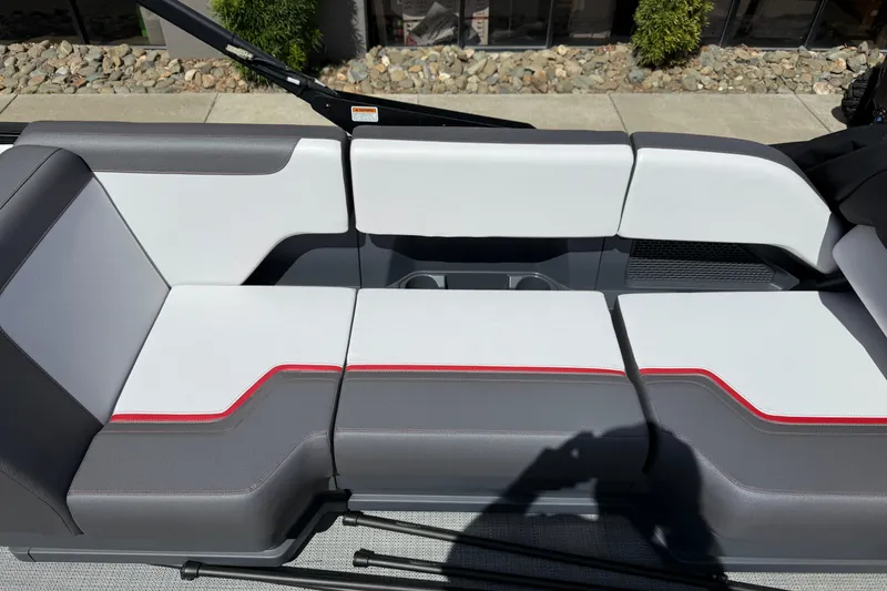 Slide: The Image of 2025 Manitou Cruise boat seating with modern design, featuring gray and white upholstery with red accents. - 11