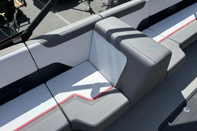 Slide: The Image of 2025 Manitou Cruise boat seating with modern gray and white upholstery, featuring red accents. - 15