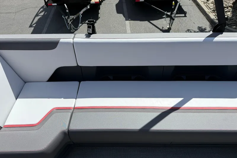 Slide: The Image of 2025 Manitou Cruise boat interior seating with modern design and red accents. - 17