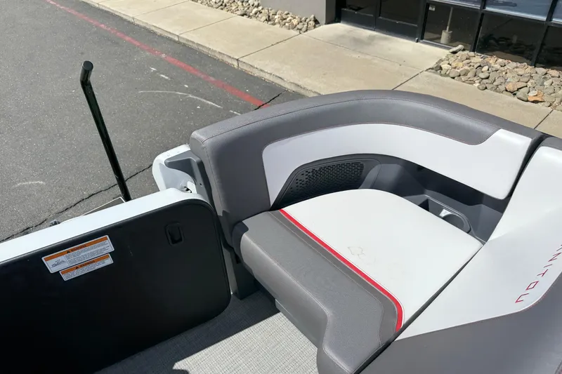 Slide: The Image of 2025 Manitou Cruise boat interior with gray and white seating, docked near a sidewalk. - 21