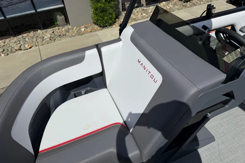 Slide: The Image of 2025 Manitou Cruise boat seat with sleek gray and white design, featuring red accents. - 22