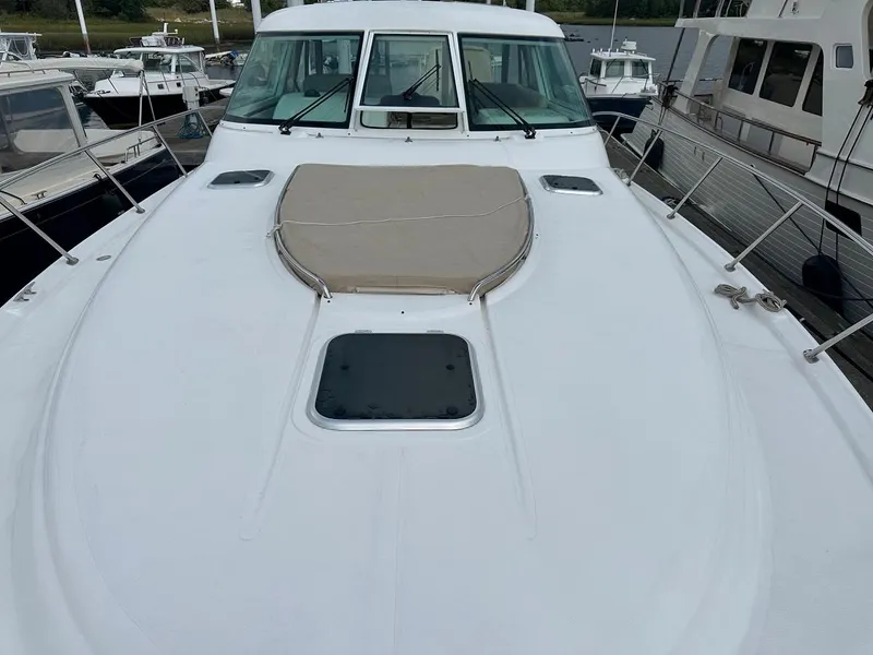 Slide: The Image of 2006 Tiara Yachts 4400 Sovran docked with dinghy. - 11