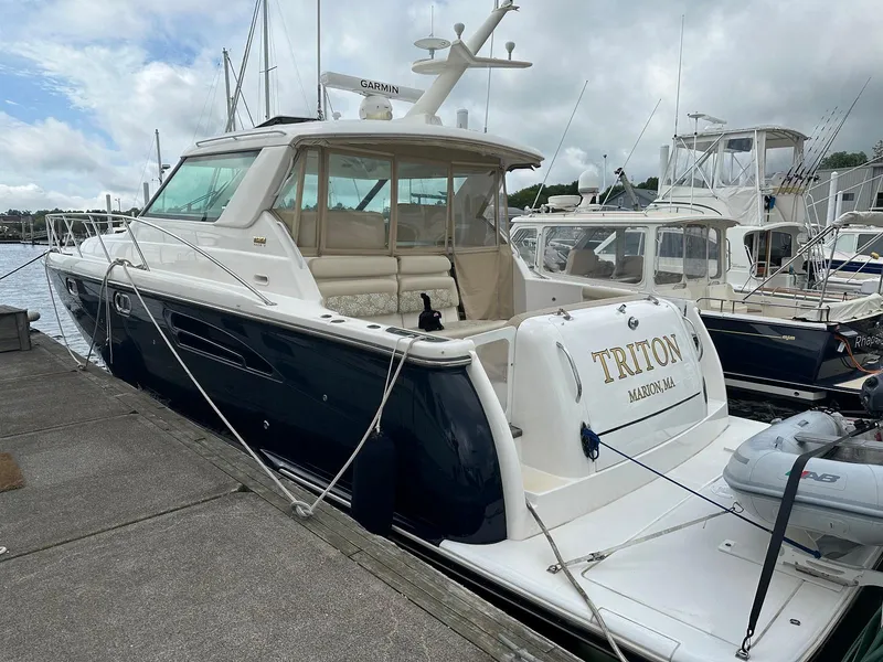 Slide: The Image of 2006 Tiara Yachts 4400 Sovran on water, American flag, coastal town backdrop. - 14