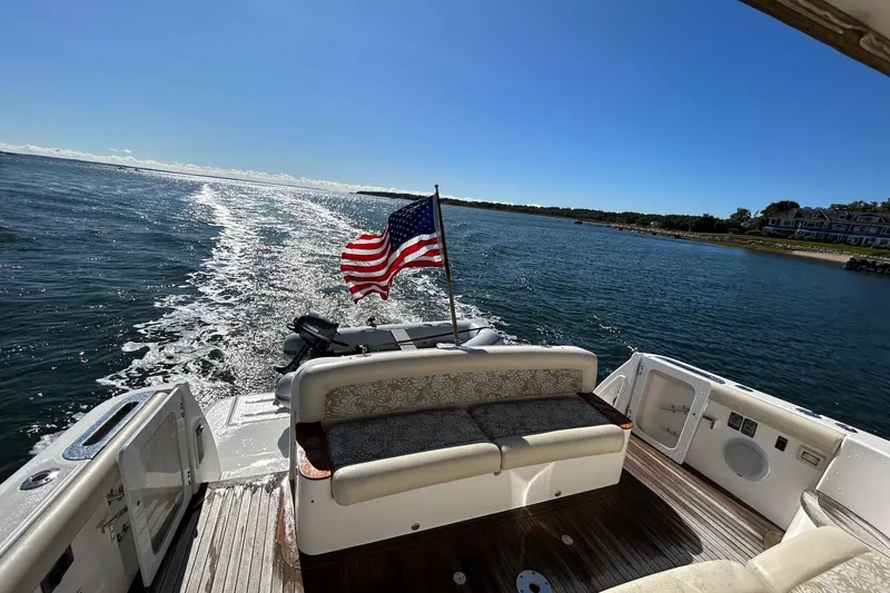 Slide: The Image of 2006 Tiara Yachts 4400 Sovran cruising with American flag, scenic ocean view. - 3