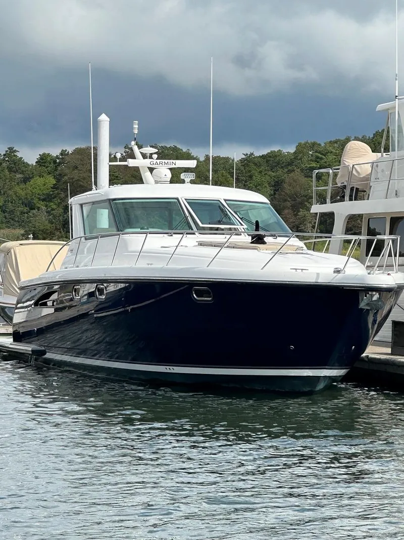 Slide: The Image of 2006 Tiara Yachts 4400 Sovran cruising on sunny waters with clear skies. - 5