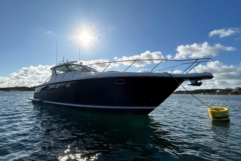 Slide: The Image of 2006 Tiara Yachts 4400 Sovran anchored on sunny day with clear skies. - 6