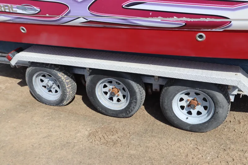 Slide: The Image of Trailer with three wheels supporting a 2016 Chaparral 287 SSX boat. - 10