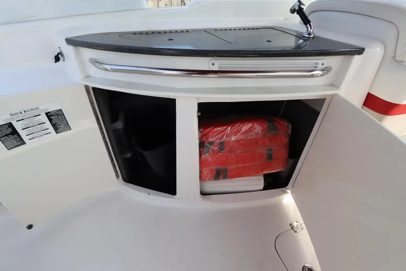 Slide: The Image of 2016 Chaparral 287 SSX boat interior storage with life jackets and sink. - 19