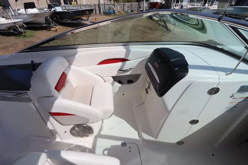Slide: The Image of 2016 Chaparral 287 SSX boat interior with white seating and dashboard. - 22