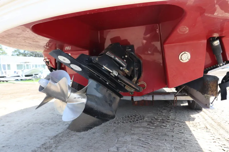 Slide: The Image of 2016 Chaparral 287 SSX boat stern with propeller and red hull. - 3