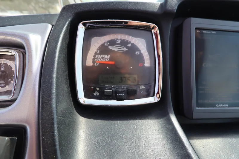 Slide: The Image of Dashboard of 2016 Chaparral 287 SSX showing RPM gauge and Garmin display. - 30