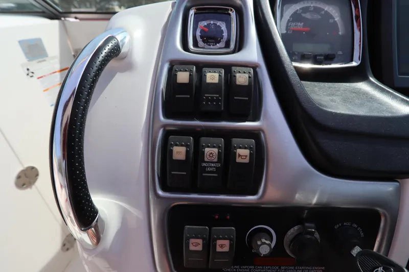 Slide: The Image of Control panel of a 2016 Chaparral 287 SSX boat with switches and gauges. - 33